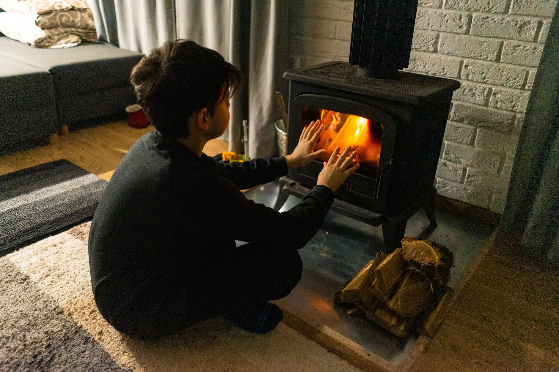 a boy getting warm ear a fireplace